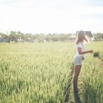 woman stand on green rice fields